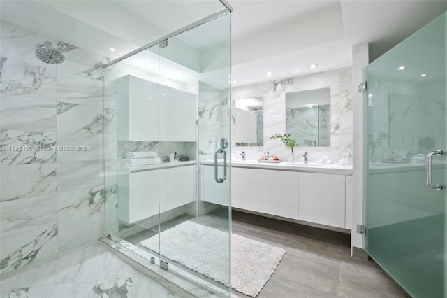 bathroom with tile patterned floors, double sink vanity, and an enclosed shower