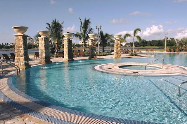 view of pool with a hot tub