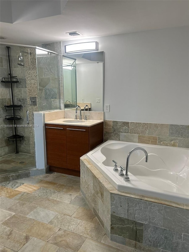 bathroom with tile patterned floors, independent shower and bath, and vanity