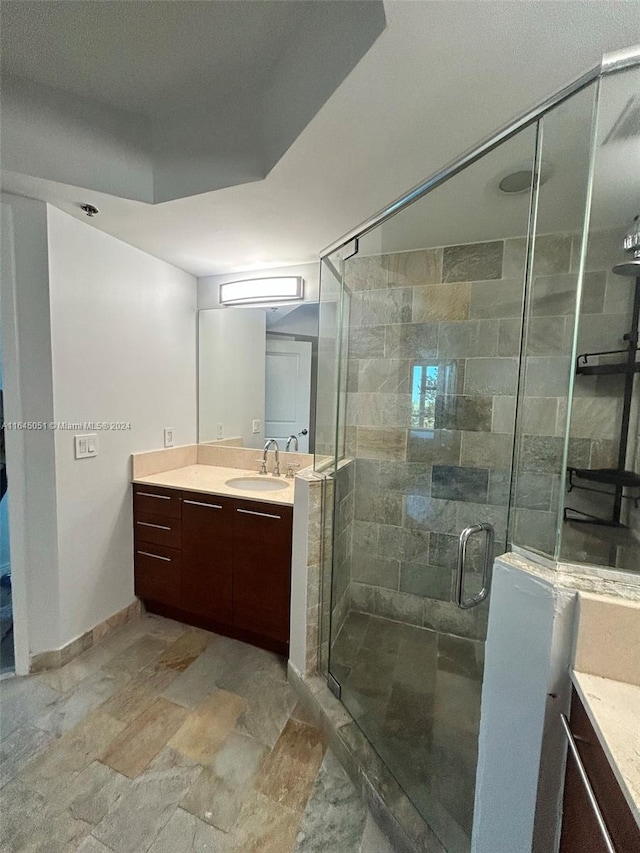 bathroom featuring an enclosed shower, vanity, and tile patterned floors