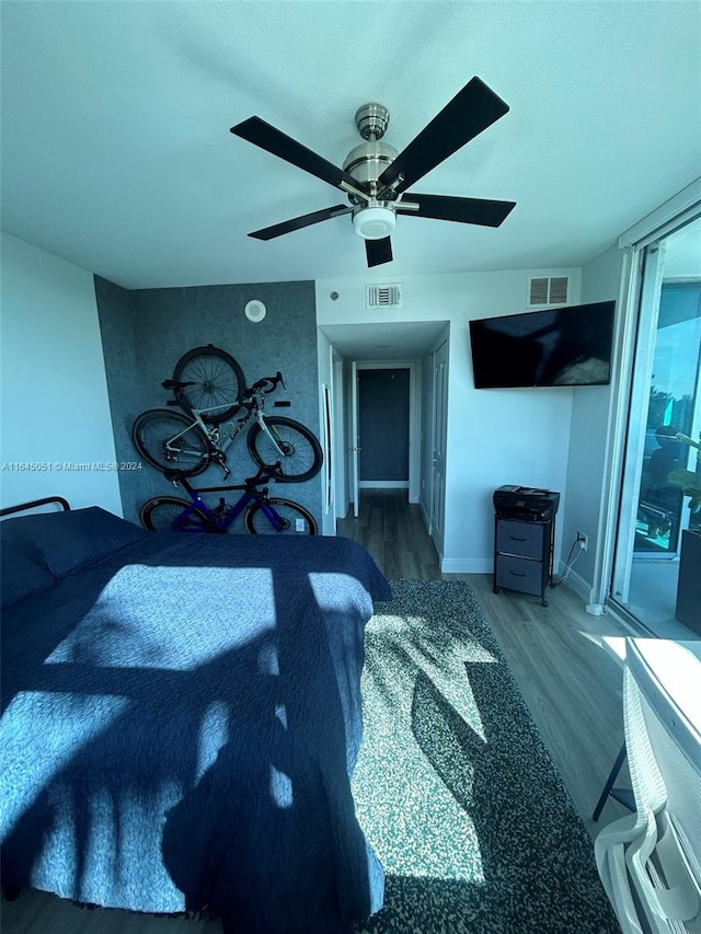 living room featuring ceiling fan and wood-type flooring