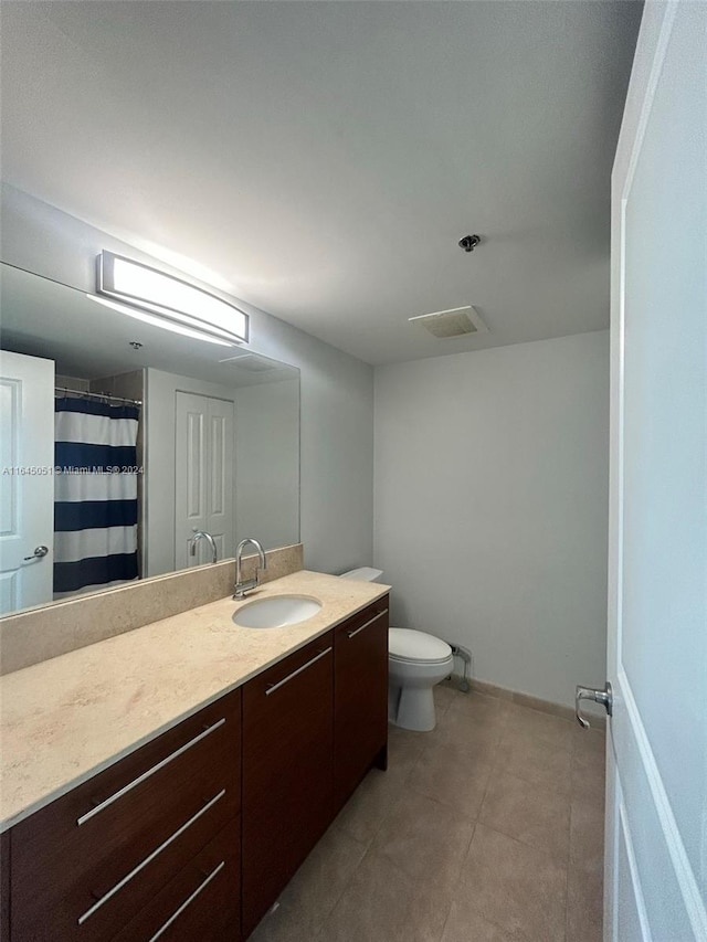 bathroom with tile patterned floors, vanity, and toilet