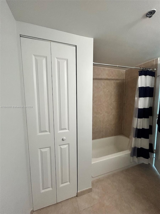 bathroom featuring shower / bath combo and tile patterned floors