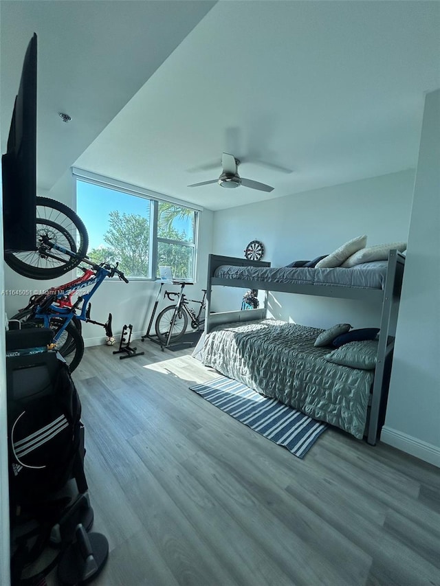 bedroom with ceiling fan and wood-type flooring