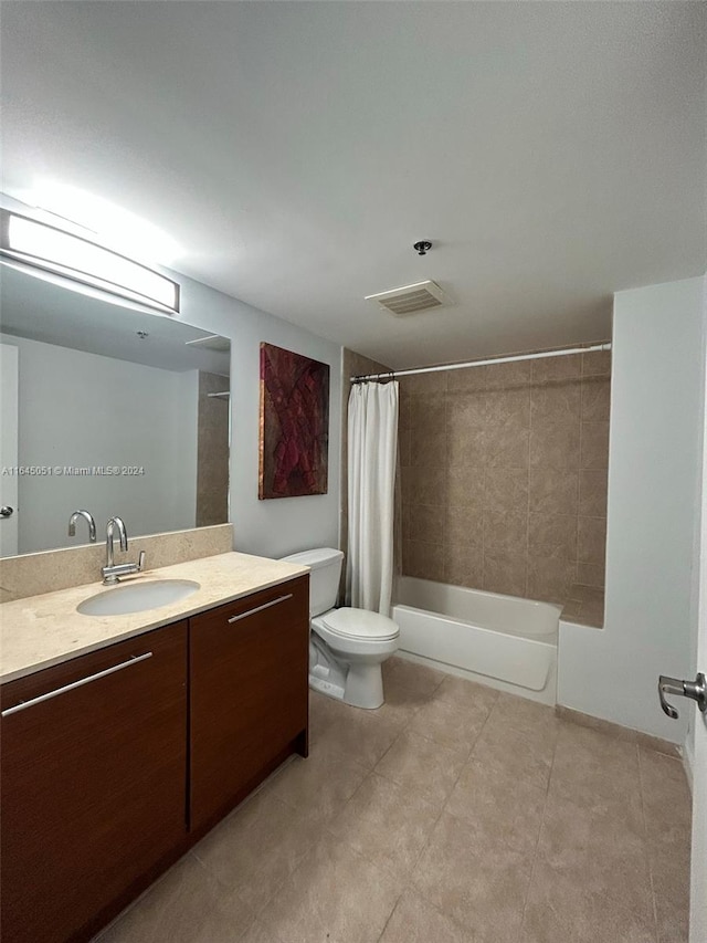 full bathroom with tile patterned flooring, shower / bath combo, toilet, and vanity