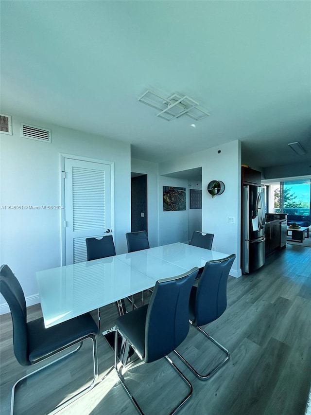 dining room with wood-type flooring