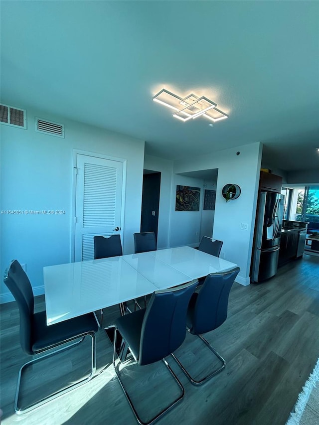 dining space with wood-type flooring