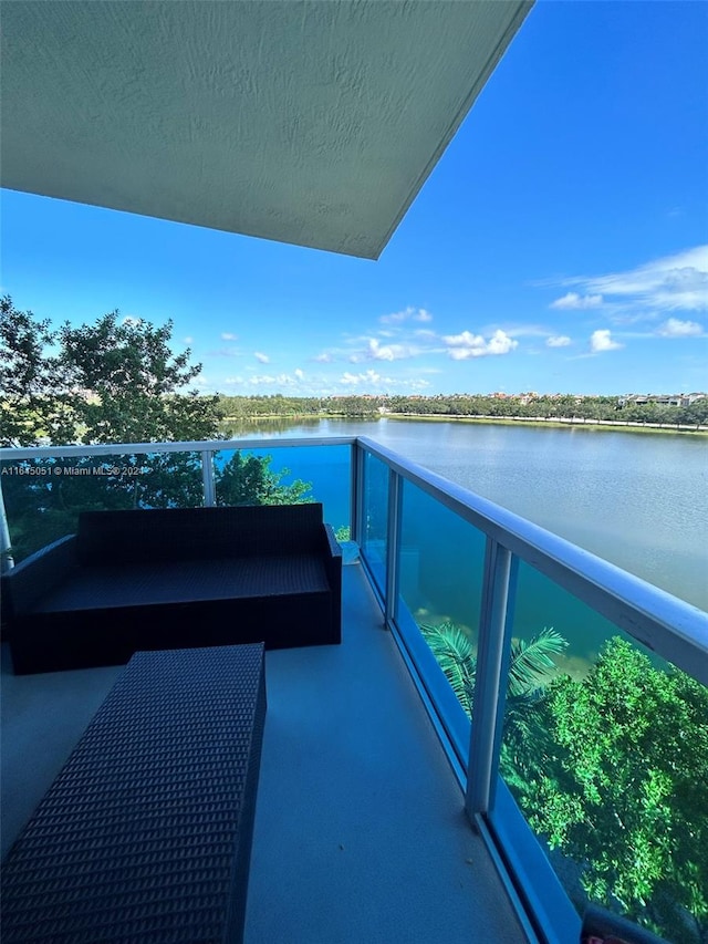 balcony featuring a water view