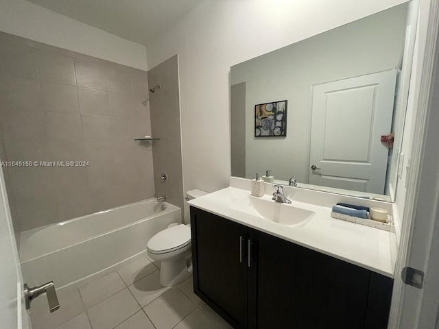 full bathroom with tiled shower / bath combo, vanity, tile patterned floors, and toilet