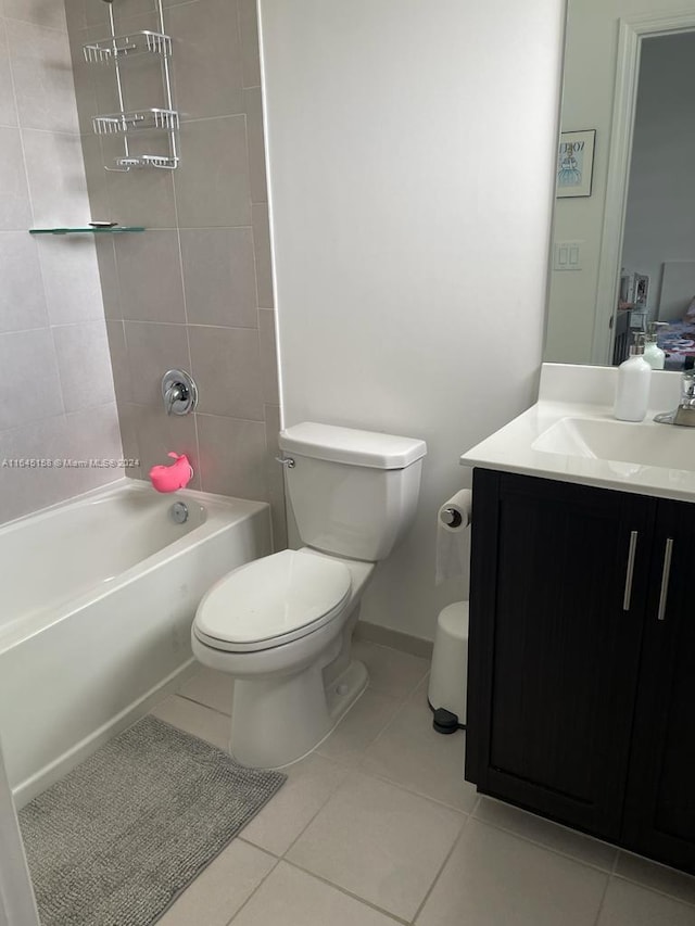 full bathroom with tiled shower / bath combo, vanity, tile patterned floors, and toilet