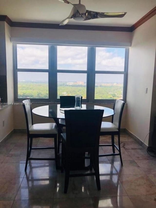 dining room featuring ceiling fan, a wealth of natural light, and tile patterned flooring