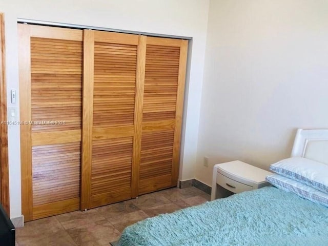 bedroom featuring a closet and tile patterned flooring