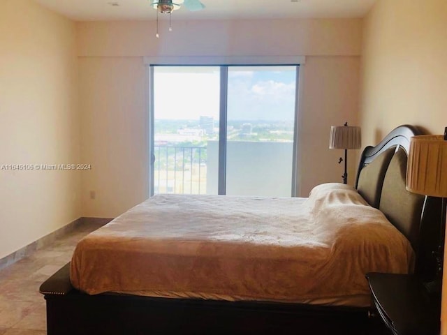 tiled bedroom with ceiling fan and access to exterior