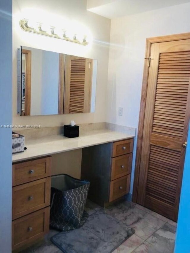 bathroom featuring tile patterned flooring and vanity