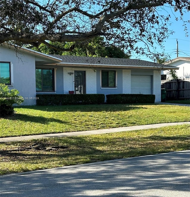 ranch-style house with a front lawn