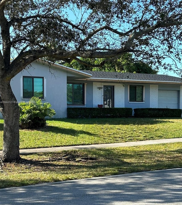 ranch-style home with a front yard