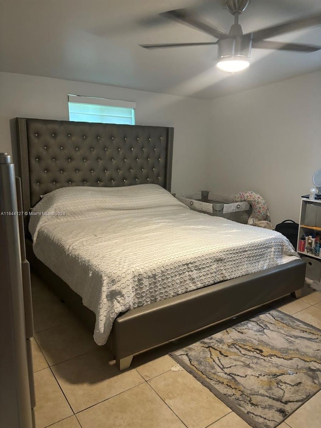 tiled bedroom featuring ceiling fan