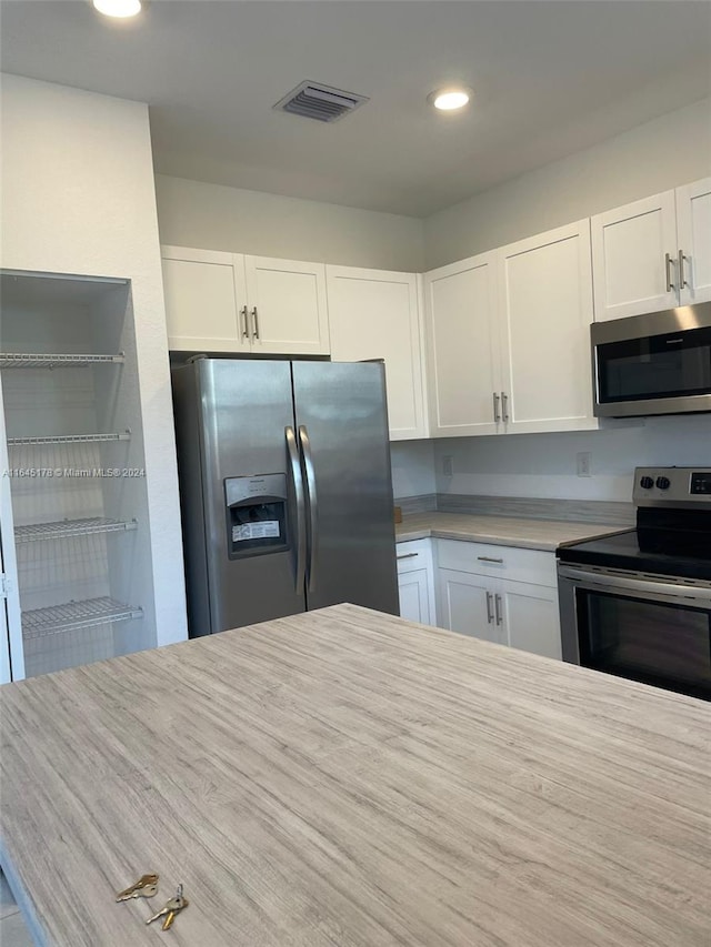 kitchen featuring white cabinetry and stainless steel appliances