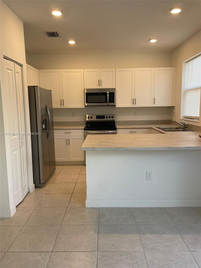 kitchen featuring sink, stainless steel appliances, and light tile patterned floors