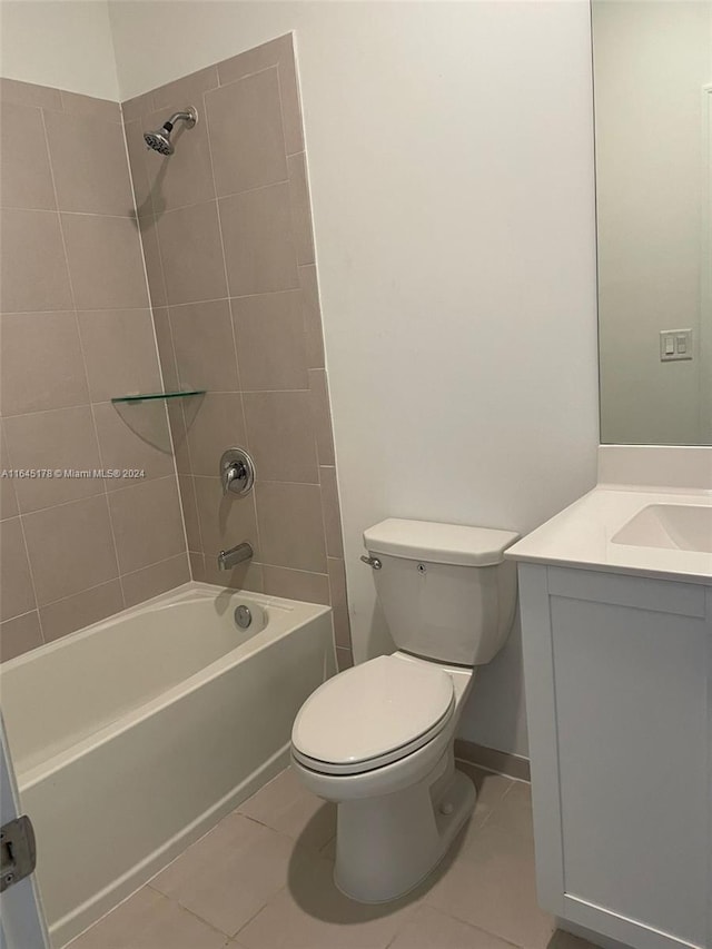 full bathroom featuring tile patterned flooring, toilet, vanity, and tiled shower / bath