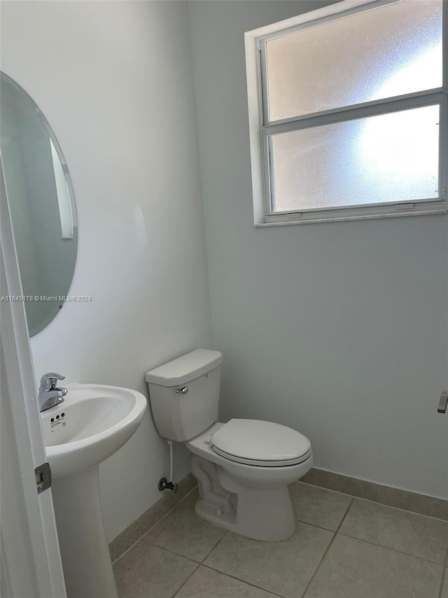 bathroom with toilet and tile patterned floors