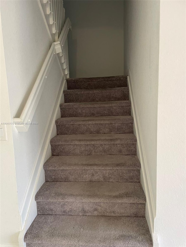 stairs featuring carpet floors