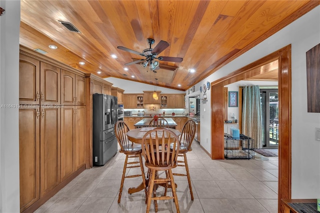 tiled dining space with ceiling fan, vaulted ceiling, and wood ceiling