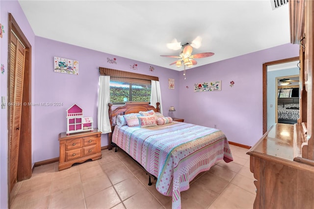 bedroom with a closet, ceiling fan, and light tile patterned flooring