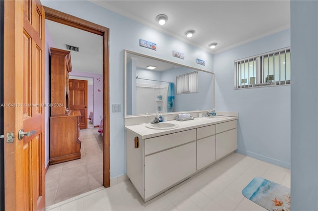 bathroom featuring tile patterned flooring and dual vanity