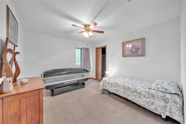 bedroom with ceiling fan and light tile patterned floors