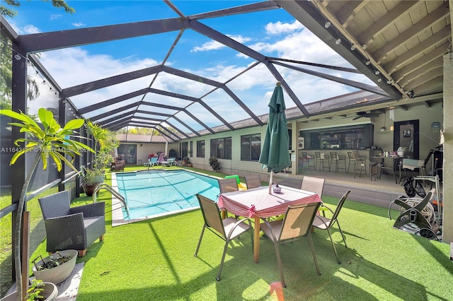 view of swimming pool featuring a patio area, glass enclosure, and ceiling fan