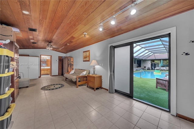 interior space featuring ceiling fan, track lighting, light tile patterned floors, wood ceiling, and lofted ceiling