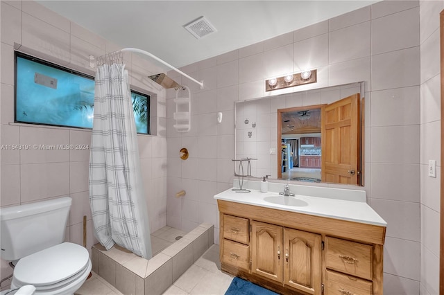 bathroom featuring tile walls, toilet, and tile patterned floors