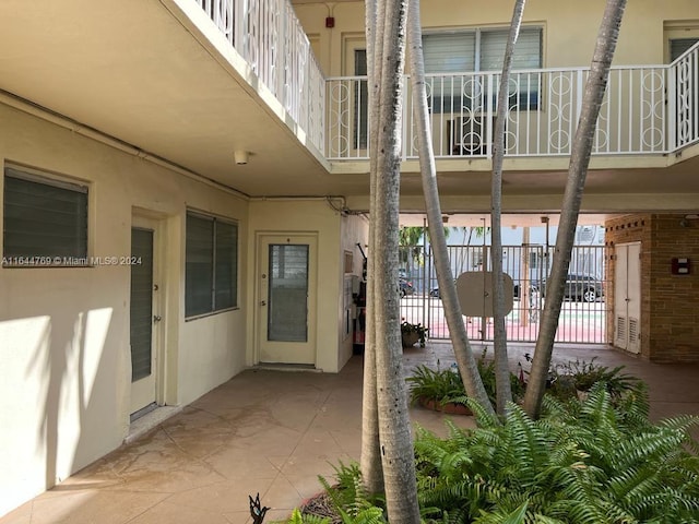 doorway to property featuring a patio and a balcony