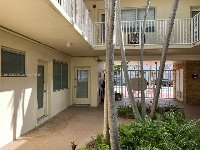 8420 Byron Ave Unit 4, Miami Beach, FL 33141 - view of patio with fence and a balcony