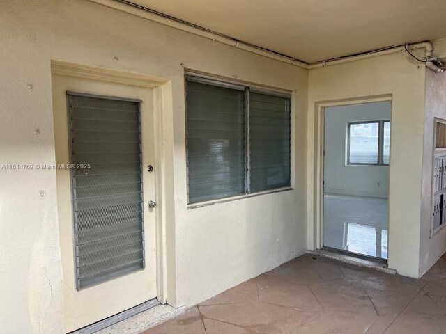 8420 Byron Ave Unit 4, Miami Beach, FL 33141 - doorway to property with stucco siding