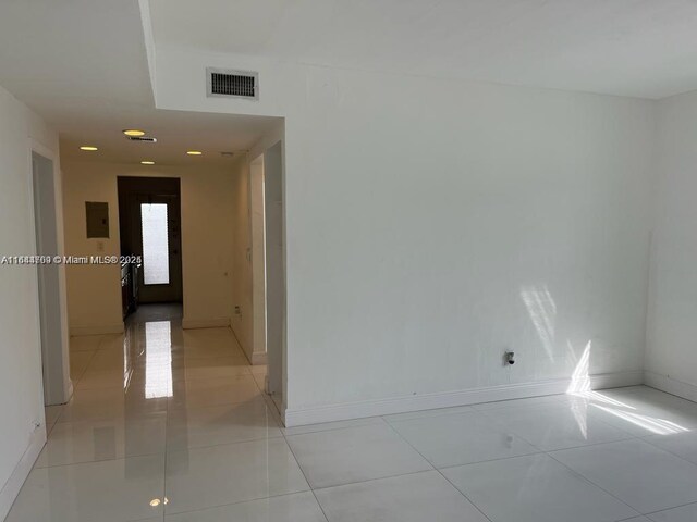 8420 Byron Ave Unit 4, Miami Beach, FL 33141 - spare room featuring light tile patterned floors and baseboards