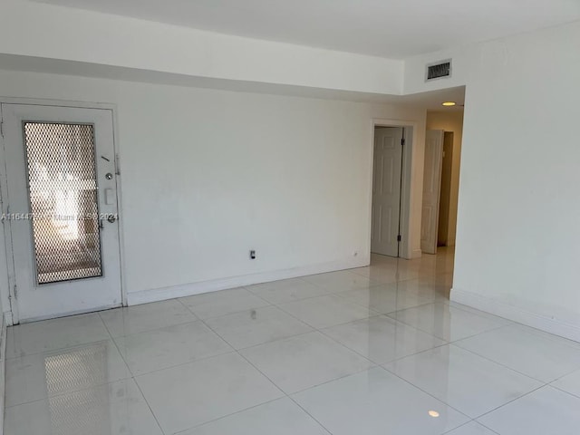 unfurnished room featuring light tile patterned floors