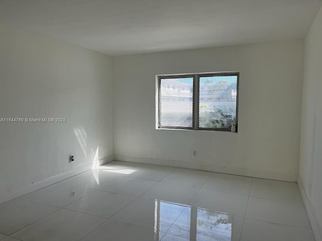 empty room with light tile patterned floors