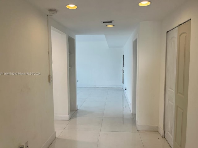 hallway with light tile patterned floors