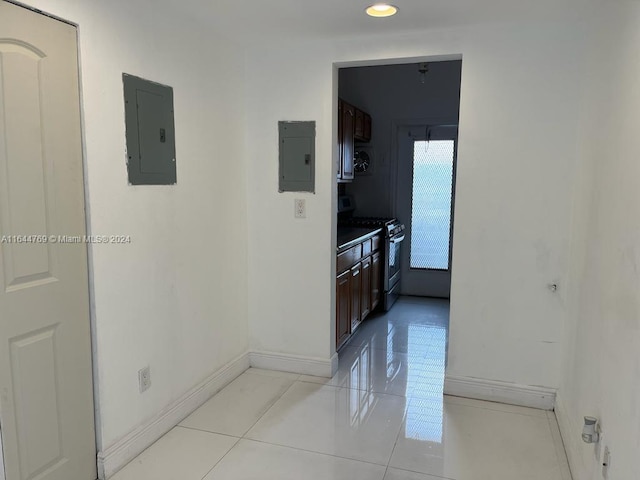 hallway with electric panel and light tile patterned floors