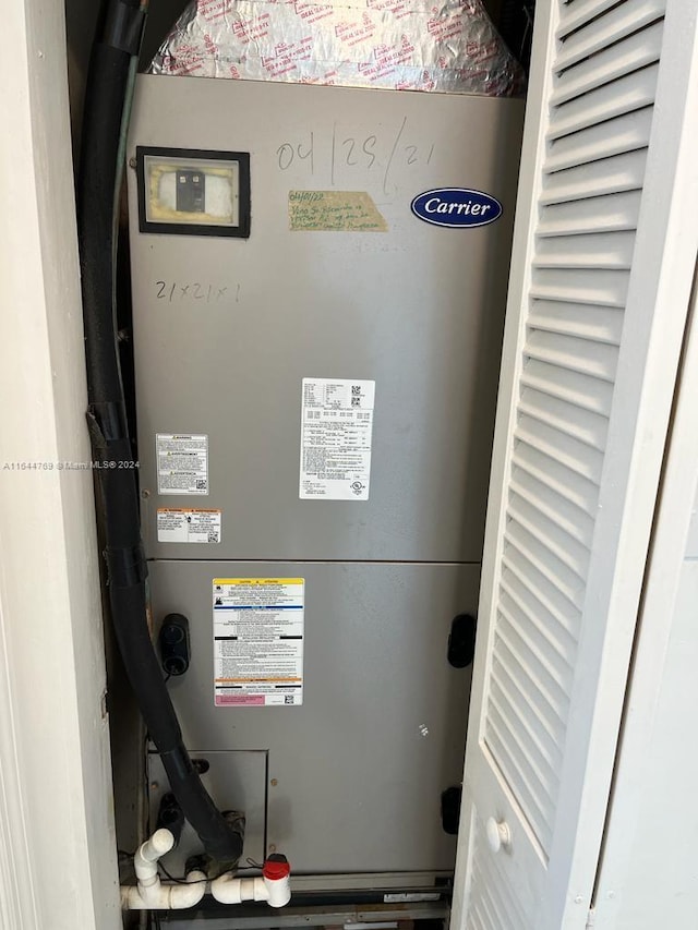 utility room featuring heating unit