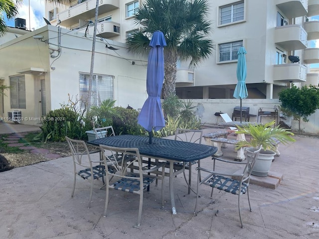 view of patio featuring a balcony and central air condition unit