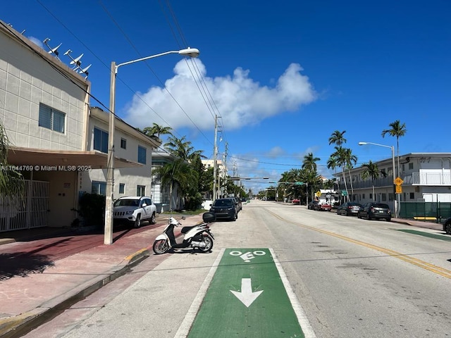 8420 Byron Ave Unit 4, Miami Beach, FL 33141 - view of asphalt street featuring street lighting, sidewalks, curbs, and traffic signs
