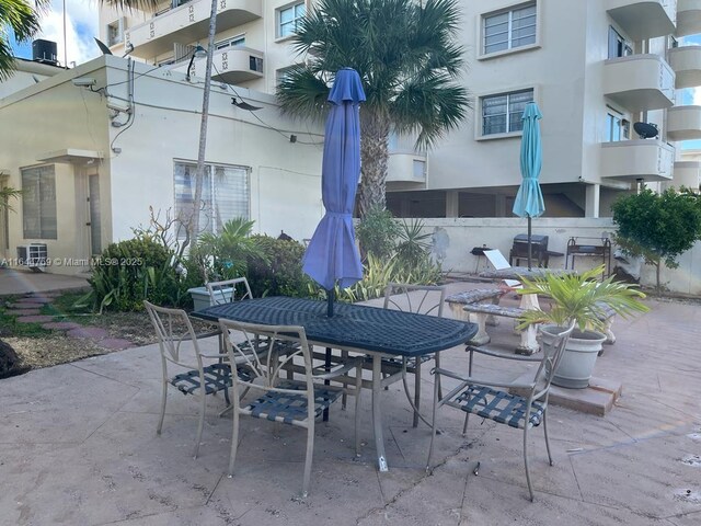 8420 Byron Ave Unit 4, Miami Beach, FL 33141 - view of patio / terrace featuring outdoor dining area and central air condition unit