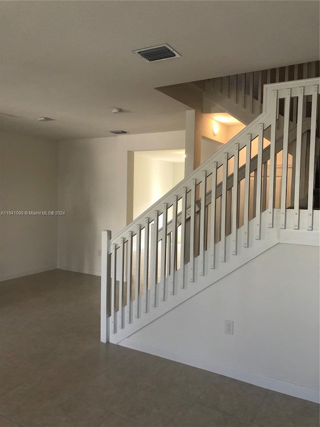 stairs featuring tile patterned floors