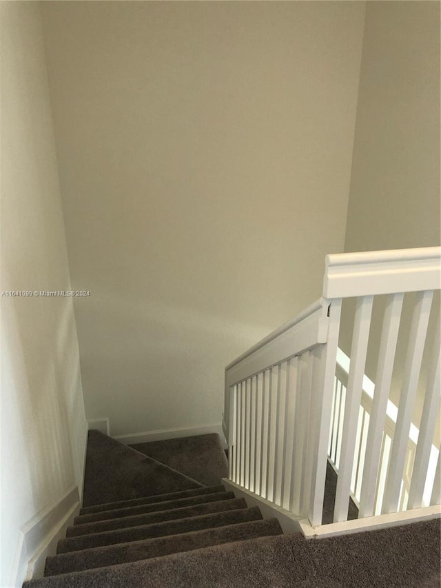 staircase with carpet flooring and baseboards