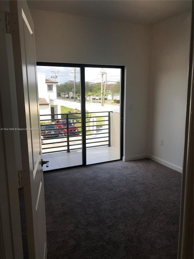 spare room with carpet floors and baseboards