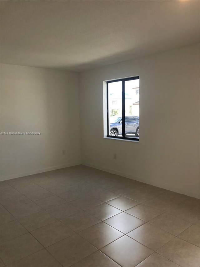 unfurnished room with light tile patterned floors