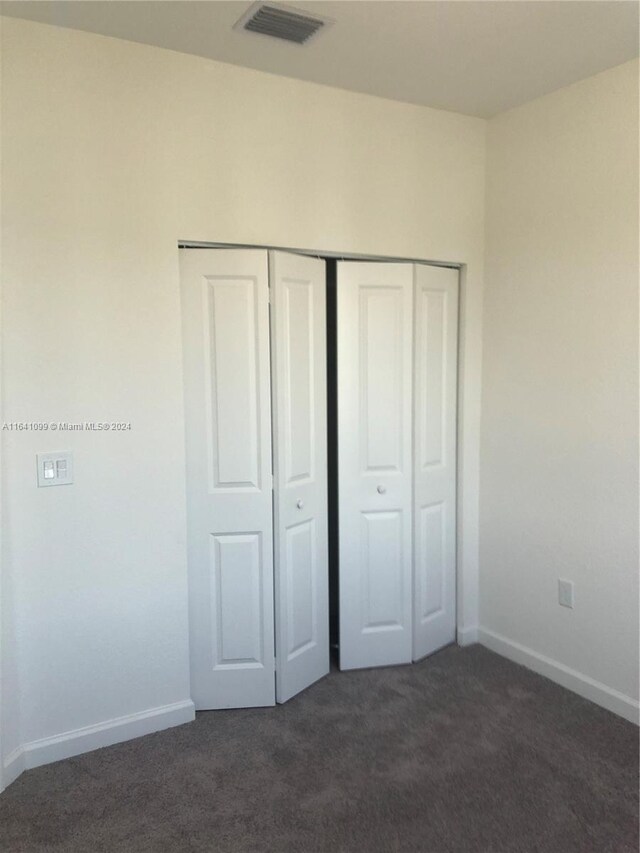 unfurnished bedroom with carpet floors and a closet